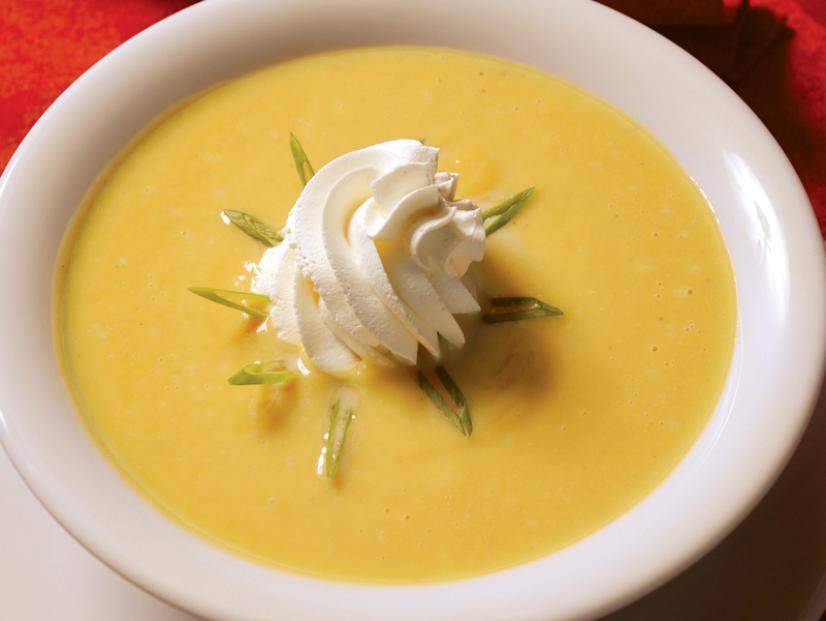 Squash Apple  Soup with Whip Cream in a Plain White Bowl