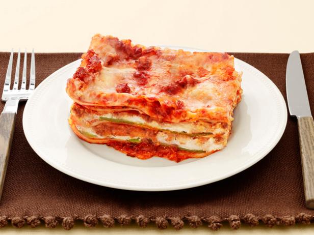 Lasagna on a White Plate and Brown Place Setting