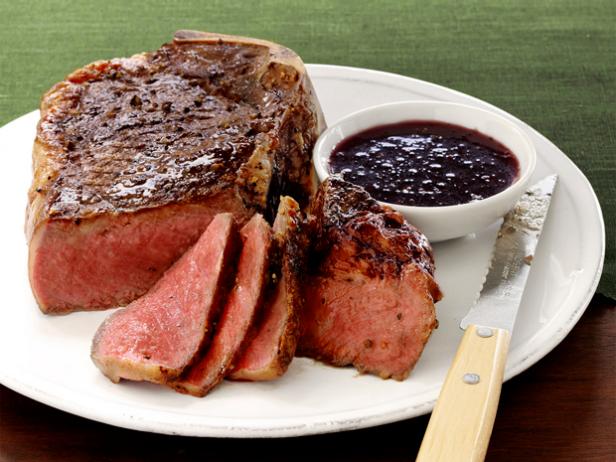 Sliced Rare Steak and Wine Shallot Sauce on a White Dish