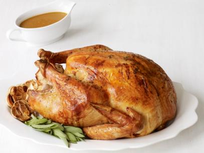 Stuffed Turkey with Gravy on a White Tablecloth