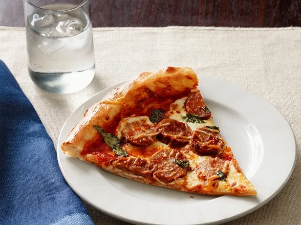 A slice of pizza and a glass of water