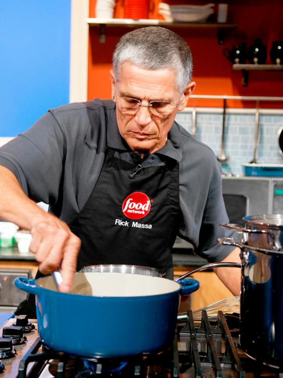 Contest Winner stirring in a large blue pot