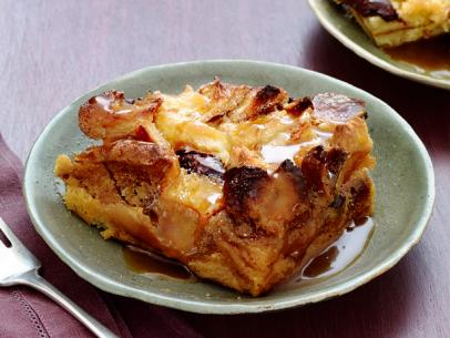 A slice of bread pudding on a small green plate