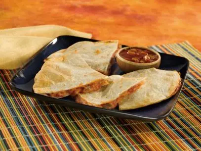 Quesadilla wedges with a side of salsa on a square black plate