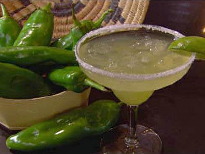 A closeup of a margarita with a wedge of lime