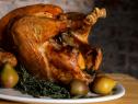 Classic roasted turkey garnished with pears and herbs.