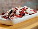 Radicchio and grape salad with pecorino and pistachios served in a white platter.