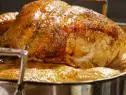 Roasted Thanksgiving turkey my way sets in a roasting pan.
