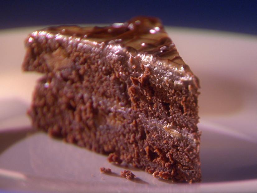 A slice of Chocolate Peanut Butter Torte on a plain white plate