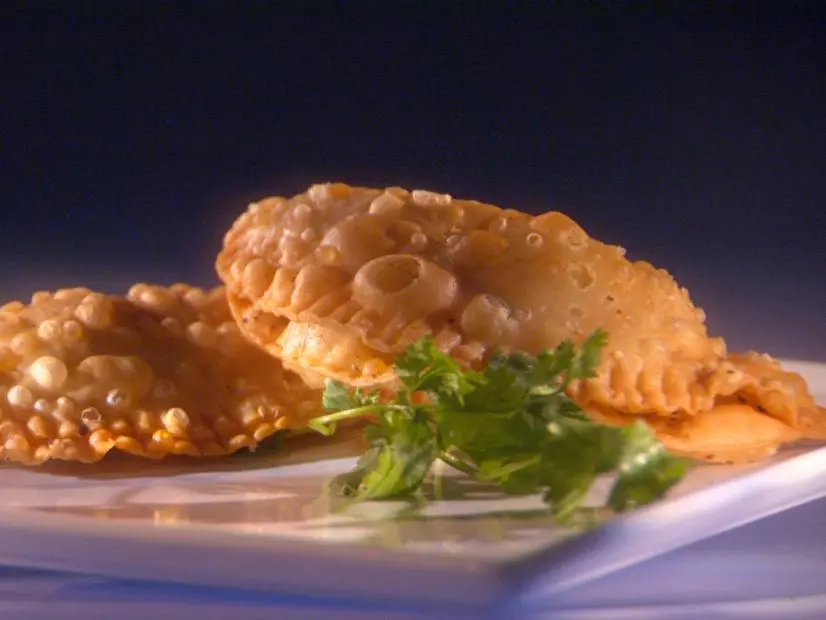 Two Fiesta Empanadas on a square white plate 