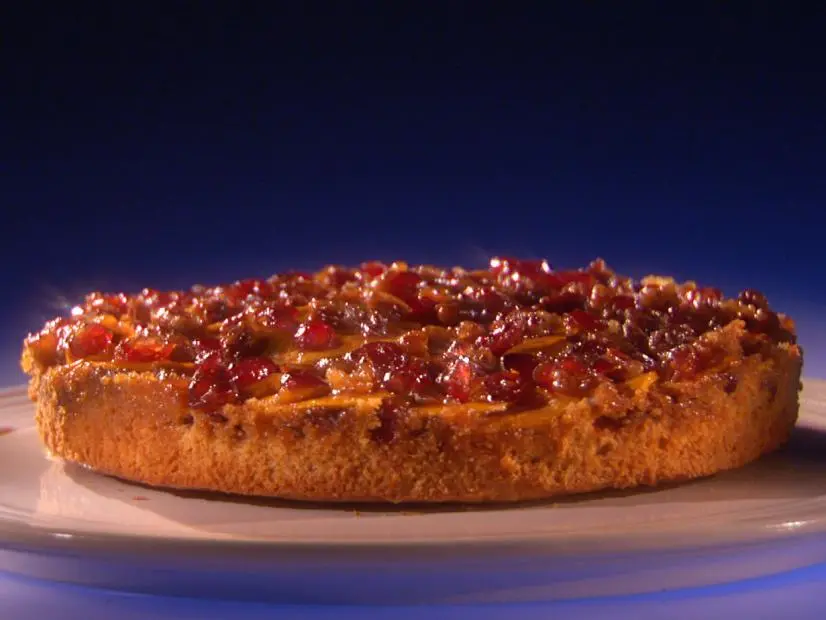 A Sweet Potato Cake on a white plate with a ridged trim