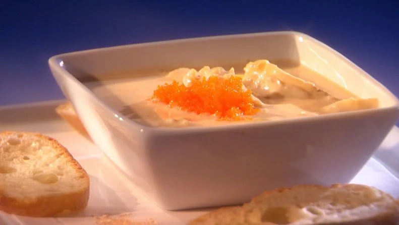 Faux Crab Soup in a square bowl placed on plate with slices of bread