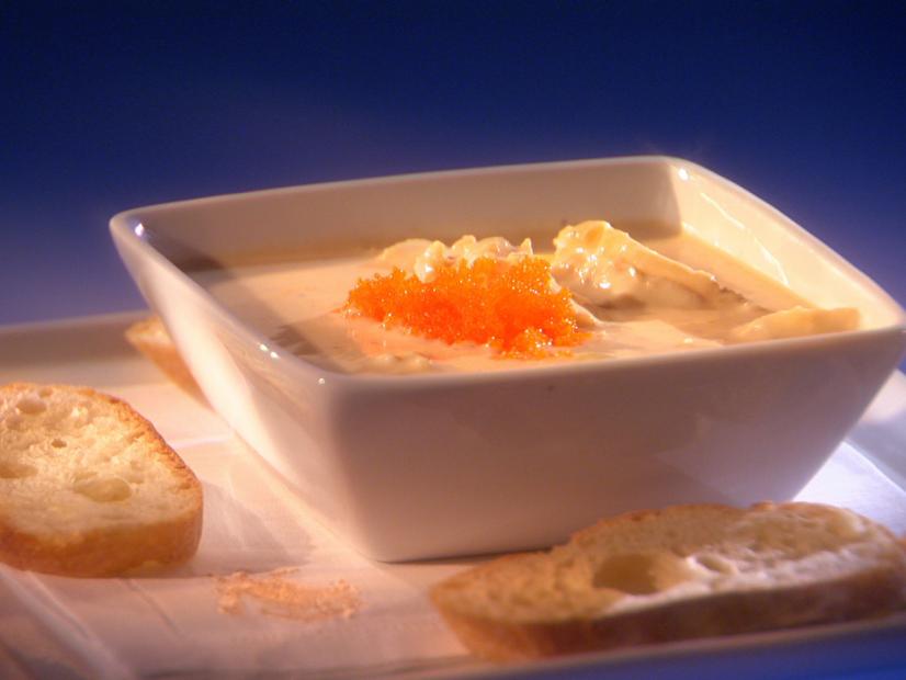 Faux Crab Soup in a square bowl placed on plate with slices of bread