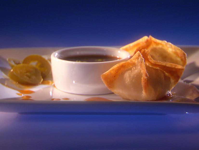 Two Texan Won Tons, sauce and slices of jajapeno on a square white plate
