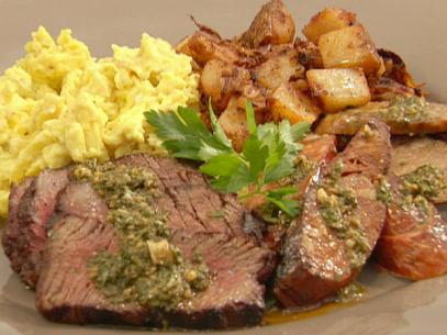 Bobby Flay makes a plate of argentinean style steak and eggs with home fries. 
