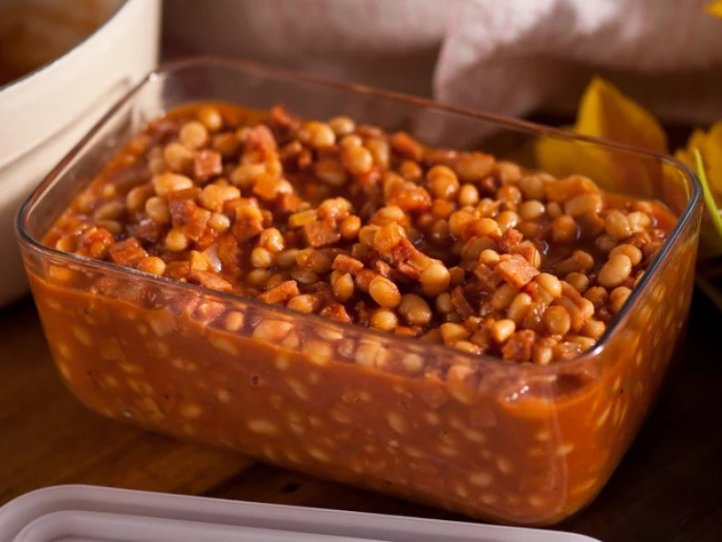 Baked Beans with Ham in a clear glass baking dish 