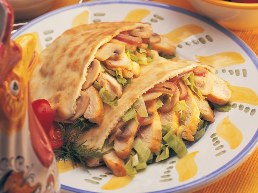 Chicken breast, mushrooms and lettuce in two pita pockets