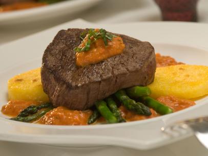 Beef Medallion on a bed of tomato sauce and vegetables