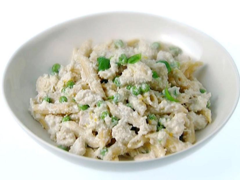 Penne with chicken, peas, and fresh basil leaves in an almond sauce.