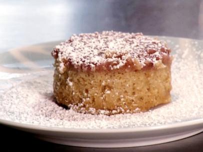 Strawberry upside down cake is sprinkled with powdered sugar.