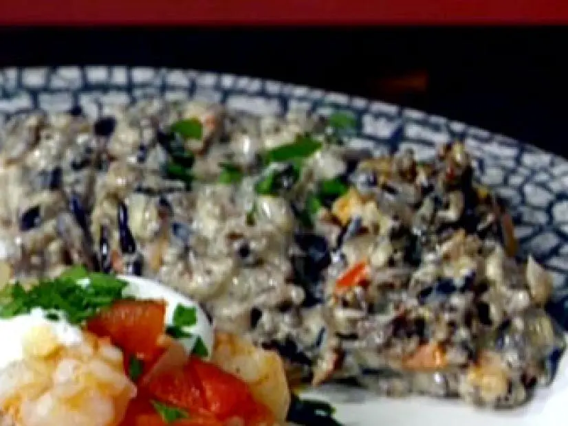 Creamy wild rice with diced carrots, celery, onions, red bell pepper, crimini mushrooms, and chopped Italian parsley leaves.