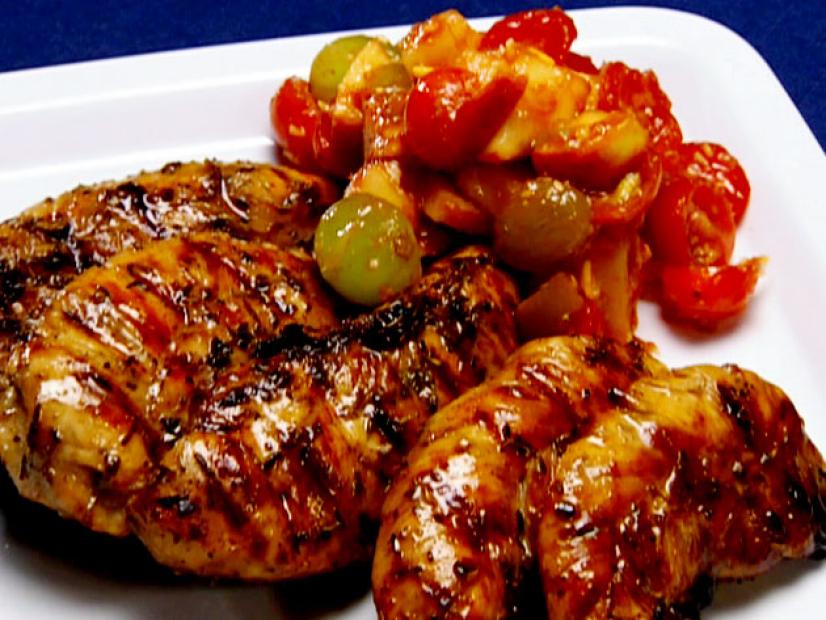 Blackened chicken with a side of fruit salsa made with pineapples, kiwi, raspberries, and strawberries.