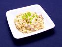 Pork ramen alfredo mixed with diced cooked ham and topped with a sprinkle of scallions.