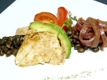 Lemon ginger poached chicken is served on a bed of black bean salad with avocado, tomatoes, and sauteed red onion.
