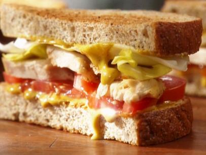 Dad's chicken sandwich is layered with honey mustard, tomatoes, endive, and roasted chicken breast on whole grain seedy bread.