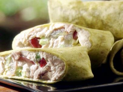 Schoolhouse wraps are tortilla wraps filled with chicken salad made with pieces of a garlic roasted chicken breast, yogurt, grapes, and celery.