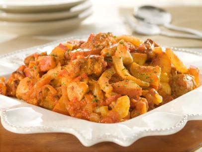 Chicken, Sausage and tomato sauce mixed with pasta on a decorative white dish