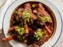 Description: Anne Burrell's Braised Lamb Shanks. Keywords: Orange, Lemon, Parsley, Garlic, Horseradish, Carrots, Celery, Lamb Shanks, Spanish Onion, Yellow Onions, Red Wine, Rosemary, Thyme, Gremolata.