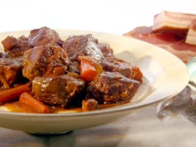 Pot roast carbonnade is cooked with bacon, onions, and carrots.
