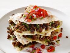 Large flour tortillas are able to accommodate generous fillings, which may be why they're so popular in Northern Mexico and the US. These satisfying quesadillas are stuffed with cheese and ground beef flavored with oregano, ancho chili powder and garlic.
