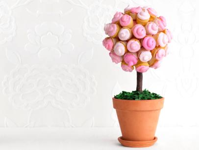 An edible topiary tree made of pink cupcakes and placed in a flower pot