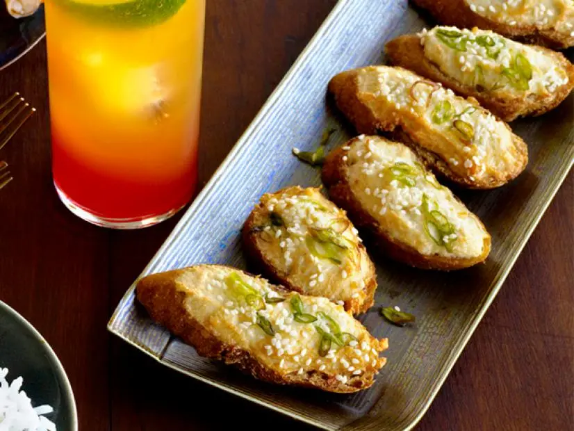 Pieces of Brushetta aligned on an rectangular dish on a wooden table