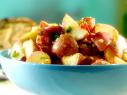 Tangy tater salad is made with red potatoes cut into cubes, chopped bacon, scallions, and jalapenos.