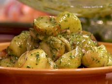 I really love baking the potatoes for this salad. It avoids using a waterlogged potato. I also love the flavor that the herbs stems give, so I leave some of them attached and part of the recipe. Most of all, this is a flavor that takes me back to a childhood picnic on the beach and feels American to me.