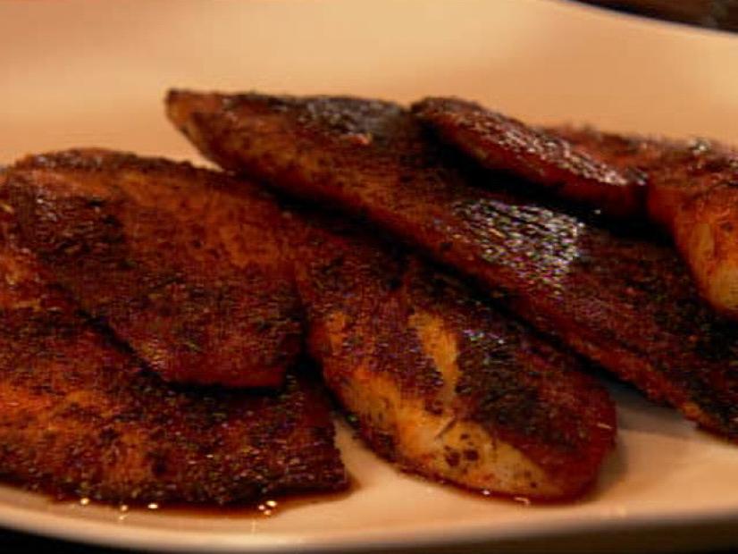 Pieces of blackened tilapia on a simple white plate