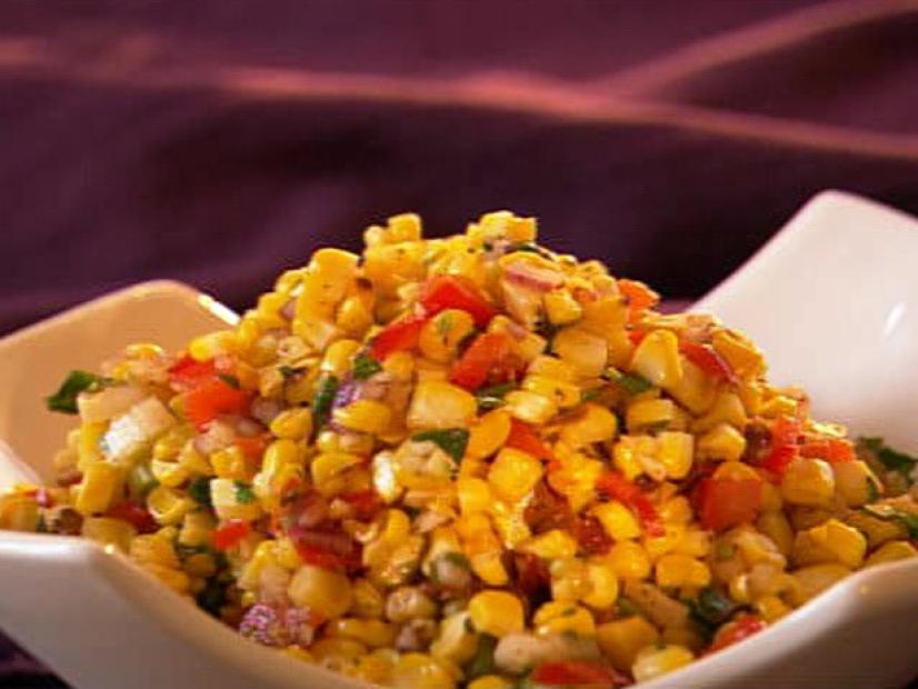 Corn and pepper mixture pile in a simple white dish