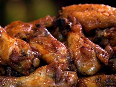 A close-up of hot wings seasoned with pepper