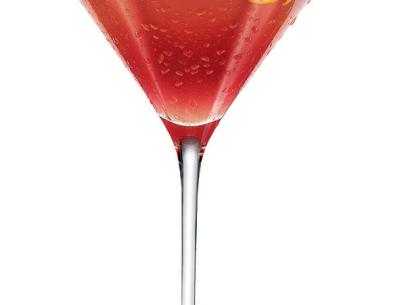 A Cosmopolitan cocktail garnished with a piece of spiral orange rind in a martini glass