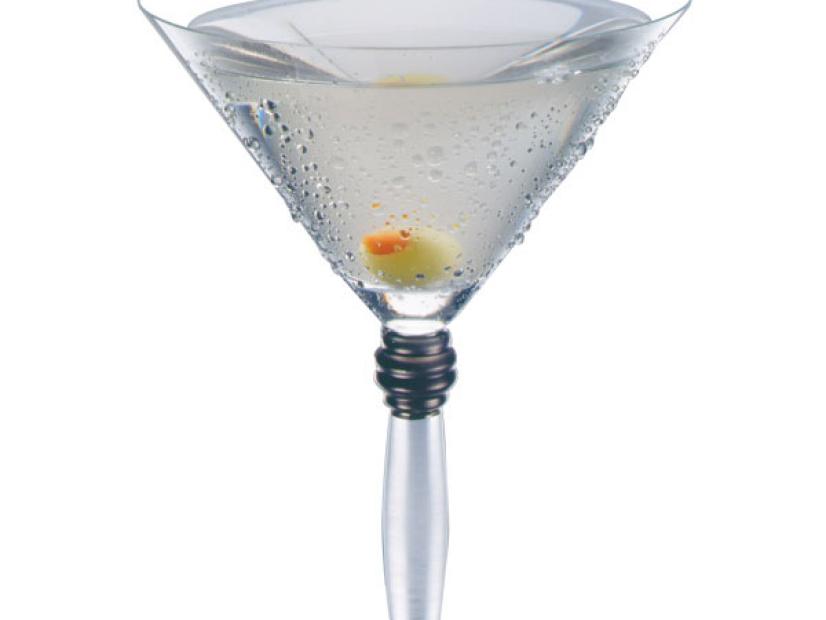 A Dirty Martini cocktail garnished with an olive in a martini glass
