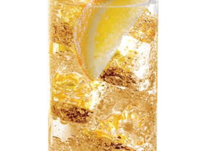 A vodka and energy drink cocktail on ice garnished with an orange slice in a highball glass
