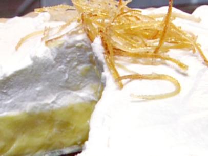 Baked lemon meringue pie is filled with lemon pudding mix and topped with a lemon whipped cream.