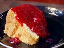 A piece of golden pound cake is topped with cranberry citrus glaze.