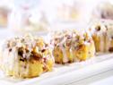 Apple walnut sticky buns with Granny Smith apple and chopped walnuts are drizzled with vanilla frosting.