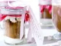 Hot chocolate jars are filled with cocoa powder, sugar, cinnamon, and marshmallows.