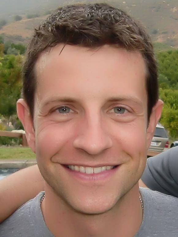 A close-up of former Season 6 Next Food Network Star Paul McCullough smiling while wearing a gray shirt