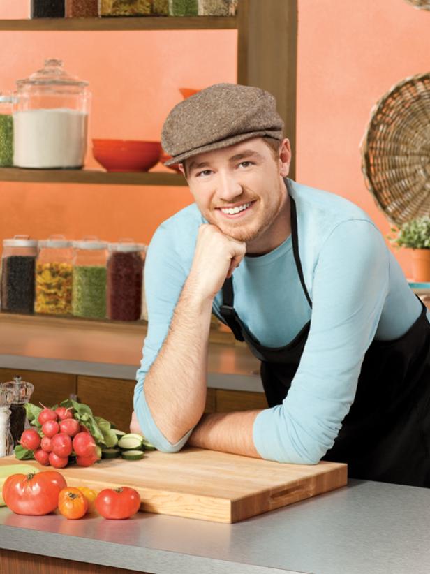 Next Food Network Star Finalist Brad Sorenson smiling while wearing a light blue shirt and black apron